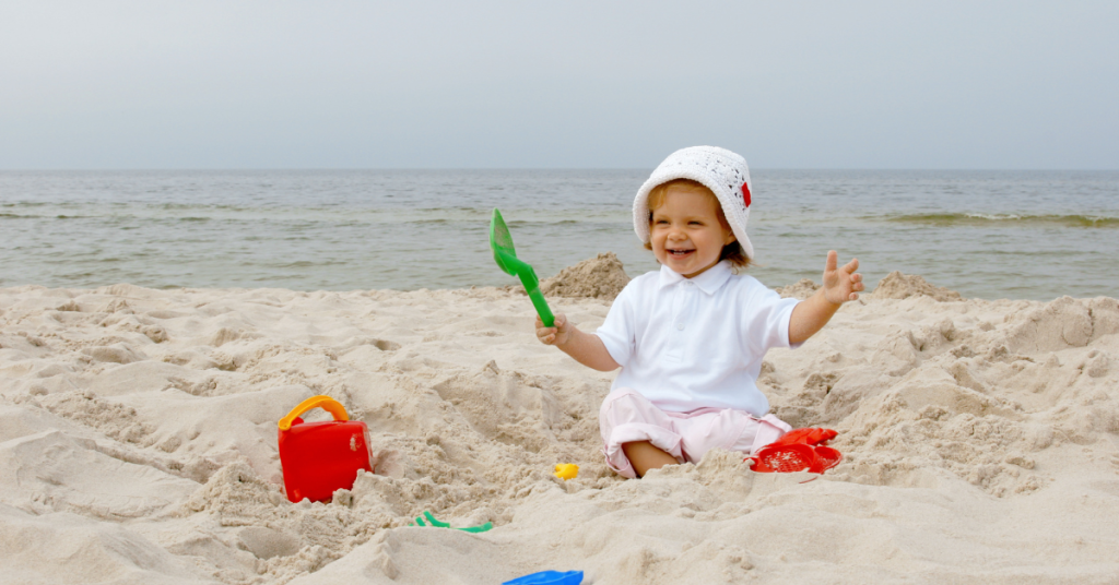 dete pravi zamak od peska na plaži